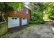 Brick home features a two-car garage, offering both convenience and curb appeal near lush greenery at 3215 E Edgewood Ave, Indianapolis, IN 46227