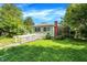 A cozy green home featuring a ramp for accessibility, and a well-maintained lawn, creating a welcoming entrance at 3215 E Edgewood Ave, Indianapolis, IN 46227