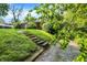 Charming single-story home with a grassy front yard and concrete stairs leading to the driveway at 3215 E Edgewood Ave, Indianapolis, IN 46227