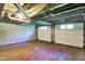 Two-car garage with painted block walls, a door opener, and good lighting, offering secure vehicle parking and storage at 3215 E Edgewood Ave, Indianapolis, IN 46227