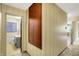 Hallway view with a large storage cabinet and bathroom at 3215 E Edgewood Ave, Indianapolis, IN 46227