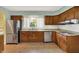 This kitchen features wooden cabinets, stainless steel appliances and sink with a window view at 3215 E Edgewood Ave, Indianapolis, IN 46227