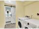 Laundry area featuring modern washer and dryer with easy access to the bathroom at 3215 E Edgewood Ave, Indianapolis, IN 46227