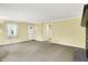 Bright and airy living room with large windows, light-colored walls, and carpeted flooring at 3215 E Edgewood Ave, Indianapolis, IN 46227