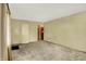 A cozy living room featuring neutral walls and carpet, with a door leading to other areas at 3215 E Edgewood Ave, Indianapolis, IN 46227