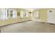 Bright living room featuring multiple windows, neutral walls, and carpeted flooring at 3215 E Edgewood Ave, Indianapolis, IN 46227