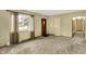 Living room featuring a large window, neutral walls, and carpeted flooring at 3215 E Edgewood Ave, Indianapolis, IN 46227