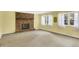 Bright living room with a brick fireplace, carpet, and large windows for natural light at 3215 E Edgewood Ave, Indianapolis, IN 46227