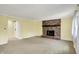 Cozy living room featuring a brick fireplace, soft carpet, and a barn door at 3215 E Edgewood Ave, Indianapolis, IN 46227