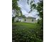 View of the home's backyard, surrounded by lush greenery and mature trees for added privacy at 3305 E 30Th St, Indianapolis, IN 46218