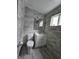 Bathroom featuring new gray marble look tile, toilet and vanity sink combo at 3305 E 30Th St, Indianapolis, IN 46218
