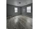 Empty bedroom featuring neutral walls, modern laminate flooring, and bright natural light at 3305 E 30Th St, Indianapolis, IN 46218