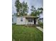 Charming bungalow featuring a well-maintained lawn, landscaped flower bed, and cozy front porch at 3305 E 30Th St, Indianapolis, IN 46218