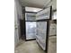 Stainless steel refrigerator with open doors showing spacious interior shelving at 3305 E 30Th St, Indianapolis, IN 46218