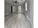 Open-concept living room features neutral walls, modern laminate flooring, and bright natural light at 3305 E 30Th St, Indianapolis, IN 46218