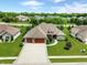 Aerial view of home with a manicured lawn, mature trees, and a three car garage at 3335 Guilford Ln, Plainfield, IN 46168