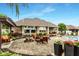 Backyard patio with a swinging bench, seating area, landscaping, and view of the house at 3335 Guilford Ln, Plainfield, IN 46168