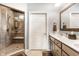Bathroom featuring double vanities, an enclosed walk-in shower, and tiled flooring for a spa-like experience at 3335 Guilford Ln, Plainfield, IN 46168