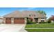 Traditional home with well-maintained lawn and mature landscaping including a two car garage at 3335 Guilford Ln, Plainfield, IN 46168