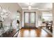 Bright foyer with hardwood floors, decorative lighting, and a view into the dining room at 3335 Guilford Ln, Plainfield, IN 46168