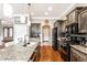 Spacious kitchen with granite island, stainless steel appliances, custom cabinets, and hardwood flooring at 3335 Guilford Ln, Plainfield, IN 46168