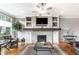 Spacious living room with a fireplace, built-in cabinets, and large windows at 3335 Guilford Ln, Plainfield, IN 46168