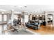 Open-concept living room with hardwood floors, a view of the kitchen, and a cozy seating area at 3335 Guilford Ln, Plainfield, IN 46168