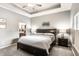 Bright main bedroom boasts tray ceilings, soft carpet, and an ensuite bathroom for a luxurious retreat at 3335 Guilford Ln, Plainfield, IN 46168