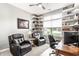 Comfortable office with multiple chairs, a desk, a ceiling fan, shelving, and large windows for natural light at 3335 Guilford Ln, Plainfield, IN 46168