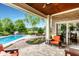 Covered patio overlooking a pool and landscaped backyard with outdoor seating, perfect for entertaining at 3335 Guilford Ln, Plainfield, IN 46168