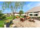 Beautiful backyard patio with seating, a fire pit, flowers, landscaping and a swinging bench at 3335 Guilford Ln, Plainfield, IN 46168