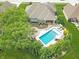 Aerial view of a backyard with a pool, lounge chairs, mature trees, and manicured landscaping at 3335 Guilford Ln, Plainfield, IN 46168