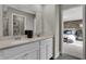 Bright bathroom featuring double sink vanity with stone countertop, large mirror and open door to the bedroom at 3449 Glasgow Pl, Danville, IN 46122