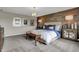 Bright bedroom featuring wood accent wall, stylish lighting, neutral carpet and decorative bench at 3449 Glasgow Pl, Danville, IN 46122