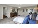 Bright bedroom featuring wood accent wall, stylish lighting, neutral carpet and abundant natural light from large windows at 3449 Glasgow Pl, Danville, IN 46122