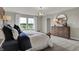 Bright bedroom featuring wood accent wall, stylish lighting, neutral carpet and abundant natural light from large windows at 3449 Glasgow Pl, Danville, IN 46122