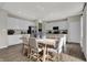 Bright dining area featuring a modern table, seating for six, and seamless transition to a white kitchen at 3449 Glasgow Pl, Danville, IN 46122