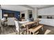 The open-concept living space with a dining area showcases a wooden table and flows into the living room at 3449 Glasgow Pl, Danville, IN 46122