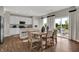 Bright dining and kitchen area featuring a center island, stainless steel appliances, and access to the outdoor space at 3449 Glasgow Pl, Danville, IN 46122