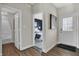 Inviting entryway boasting a modern door, stylish flooring, and views into the bedroom and bathroom at 3449 Glasgow Pl, Danville, IN 46122
