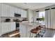 Kitchen island featuring granite countertops, stainless steel appliances, and seating for three on stylish stools at 3449 Glasgow Pl, Danville, IN 46122