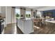 Bright kitchen view showcasing an island with seating, seamlessly connecting to the adjacent living area at 3449 Glasgow Pl, Danville, IN 46122