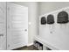 Well-organized mudroom with bench seating, storage baskets, and hooks for easy organization at 3449 Glasgow Pl, Danville, IN 46122