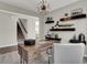 Well-lit office featuring stylish desk, decor, and shelving leading into an open-concept area with stairway at 3449 Glasgow Pl, Danville, IN 46122