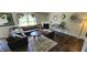 Spacious living room with a large sectional, fireplace, decorative mirrors, and hardwood flooring at 409 Spring Green Pl, Indianapolis, IN 46229