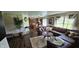 Open concept living room with a sectional sofa, hardwood floors, and a view into the kitchen at 409 Spring Green Pl, Indianapolis, IN 46229