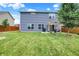 Expansive backyard featuring a well-maintained lawn, patio area, and blue vinyl siding at 442 Mozart Dr, Greenfield, IN 46140