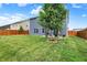 Spacious backyard featuring a healthy lawn, privacy fence, and mature tree at 442 Mozart Dr, Greenfield, IN 46140