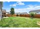 Expansive backyard featuring a well-maintained lawn, wooden fence, fire pit, and a charming pergola at 442 Mozart Dr, Greenfield, IN 46140