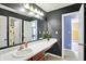 Stylish bathroom vanity with sink, mirror, and view into an adjacent room at 442 Mozart Dr, Greenfield, IN 46140